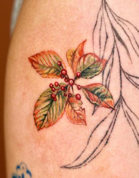 Fabulous-Orange-Leaves-Tattoo-on-Arm 